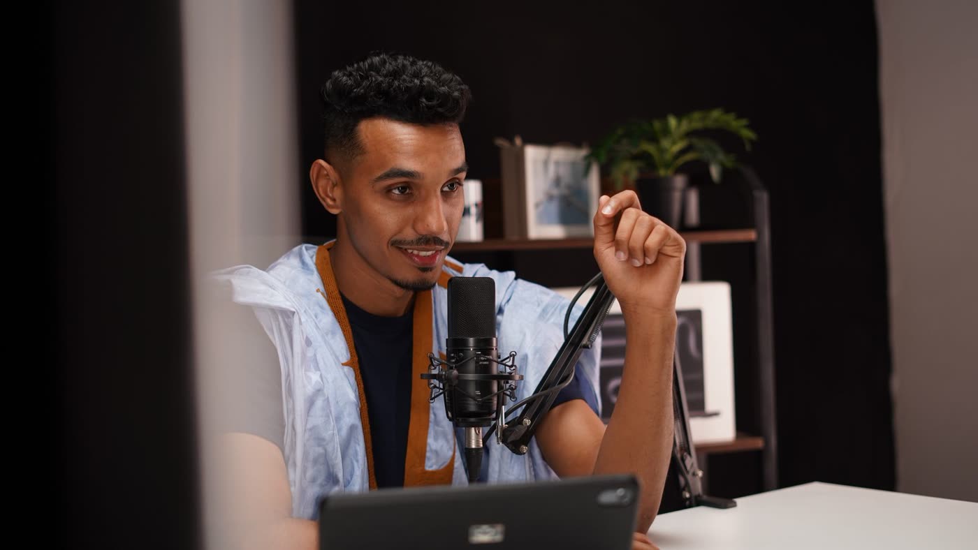 Creator recording a video at a studio microphone